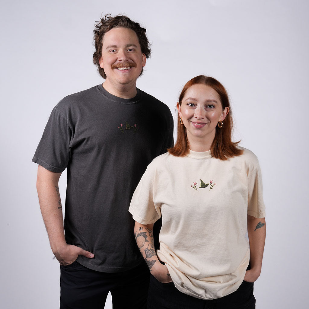 two people wearing WICKED: FOR GOOD T-Shirts in Charcoal and Ivory