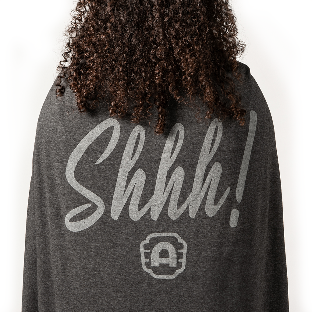 woman wrapped in Alamo Drafthouse Shhhhhhh! Sweatshirt Blanket