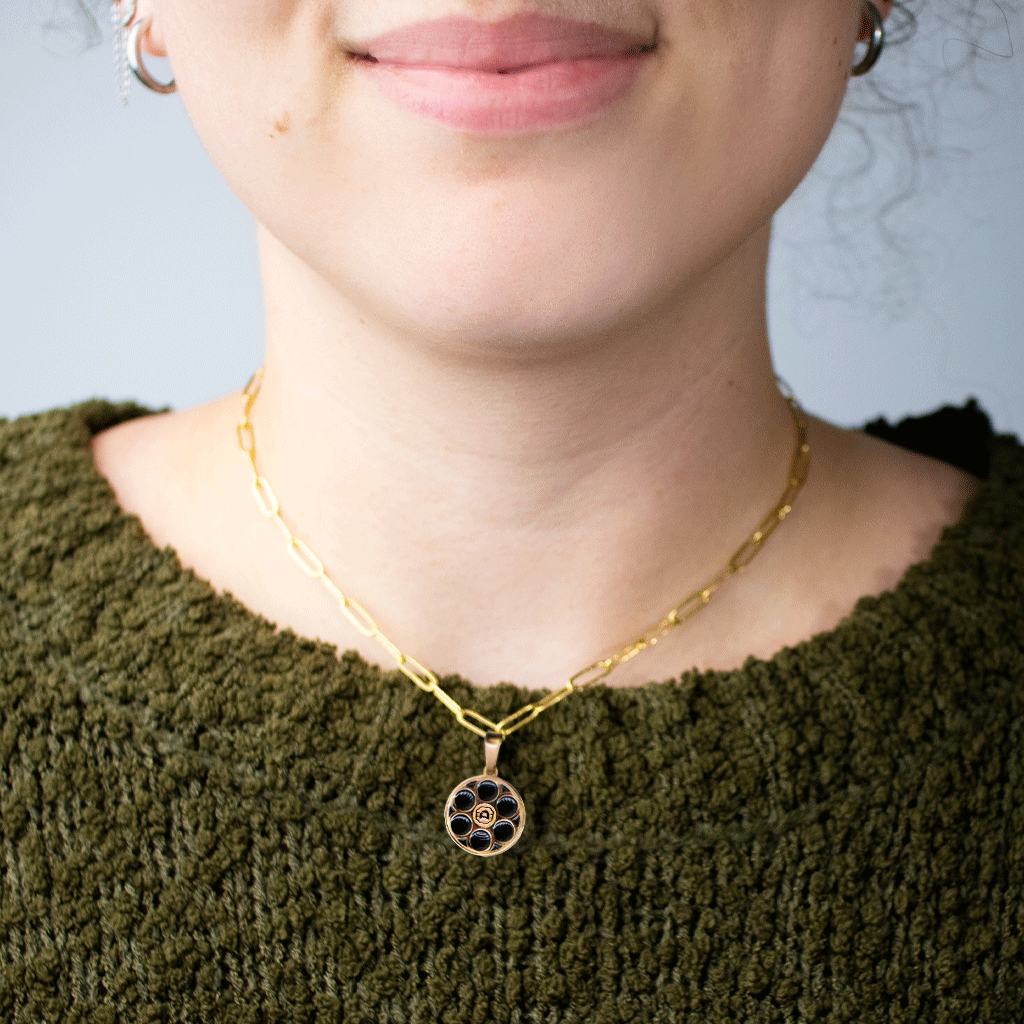woman wearing Alamo Drafthouse Film Reel Charm