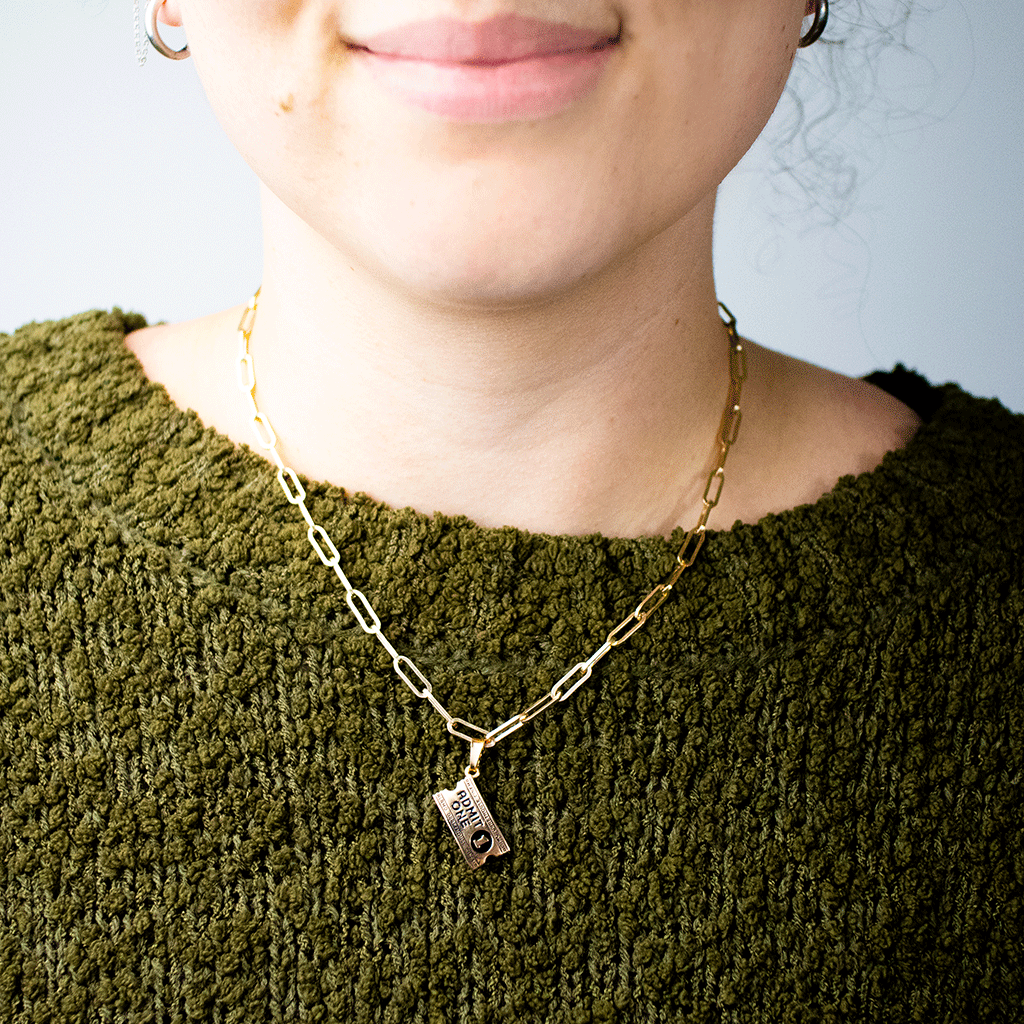woman wearing Alamo Drafthouse Movie Ticket Charm