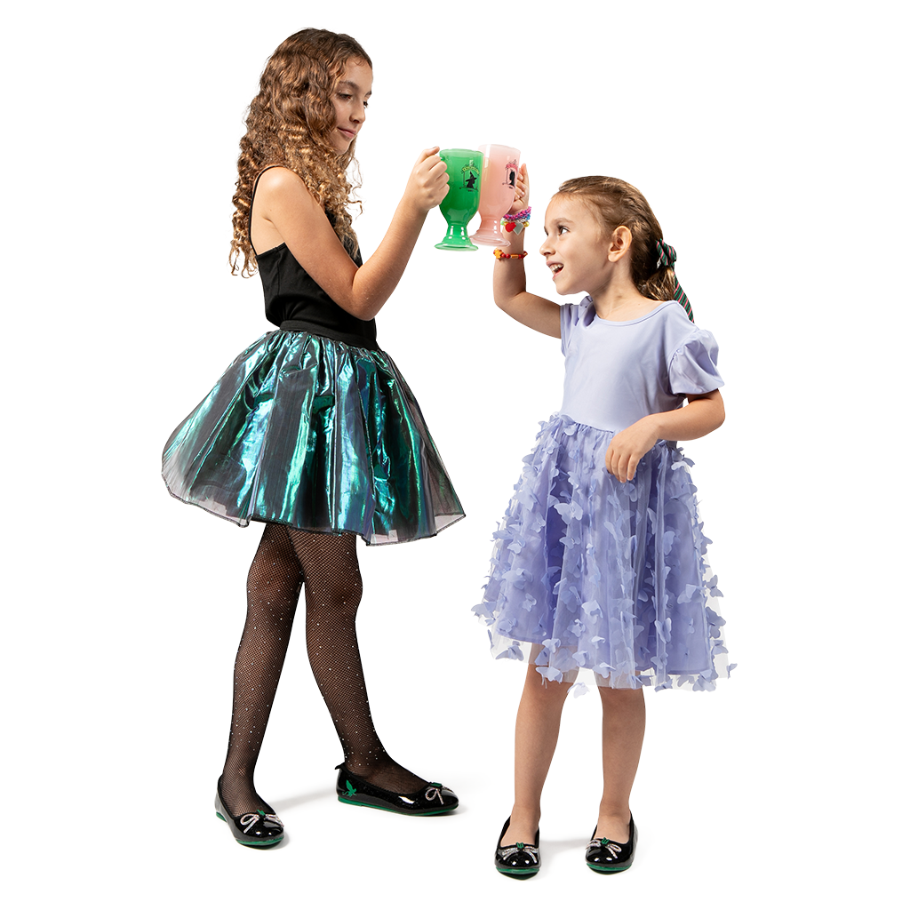 girls holding WICKED X Alamo Drafthouse Collectible Glinda Cocoa Mug and WICKED X Alamo Drafthouse Collectible Elphaba Cocoa Mug