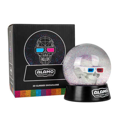 Alamo Drafthouse 3D Skull Snow Globe next to its packaging