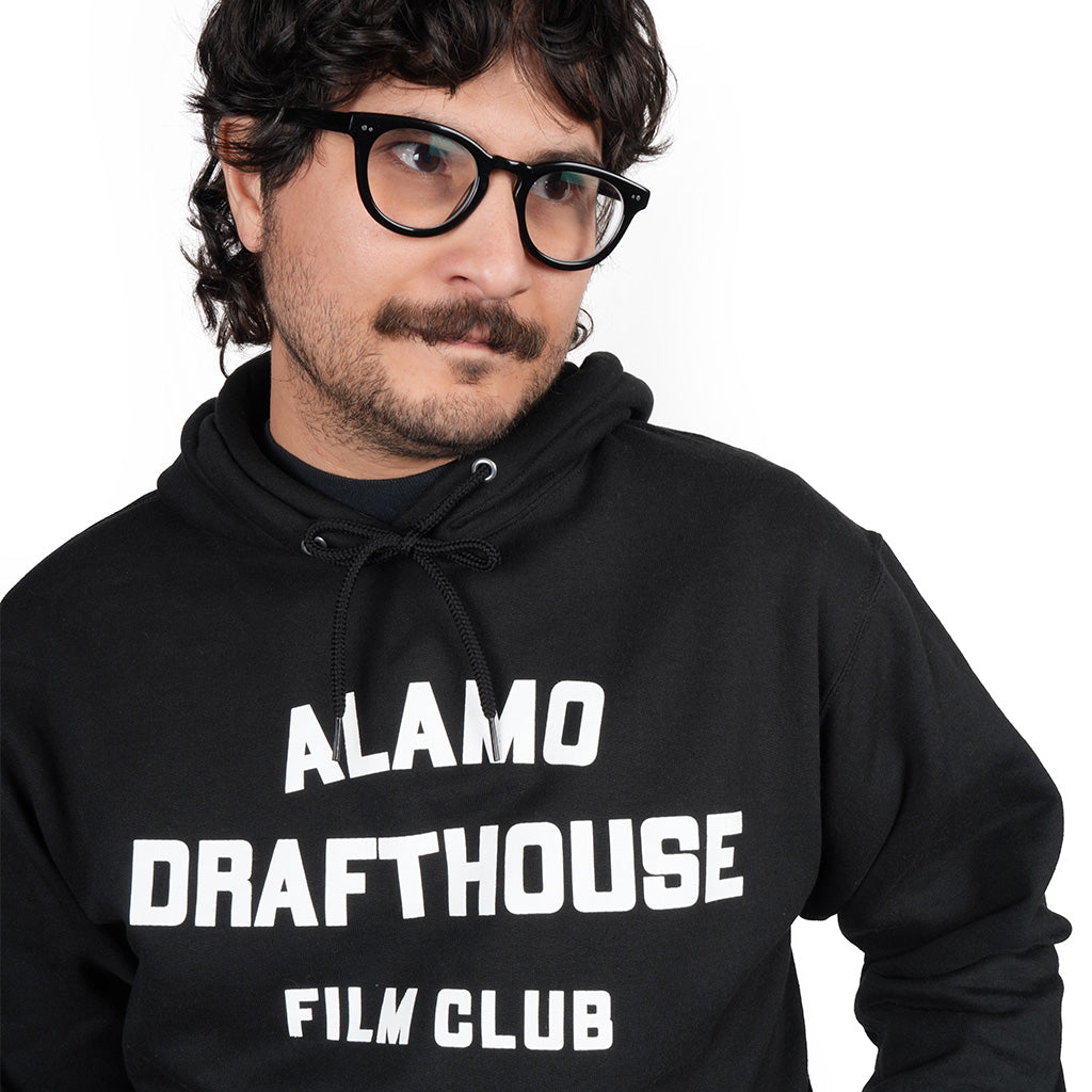 close-up of man wearing Alamo Drafthouse Film Club Hoodie in black