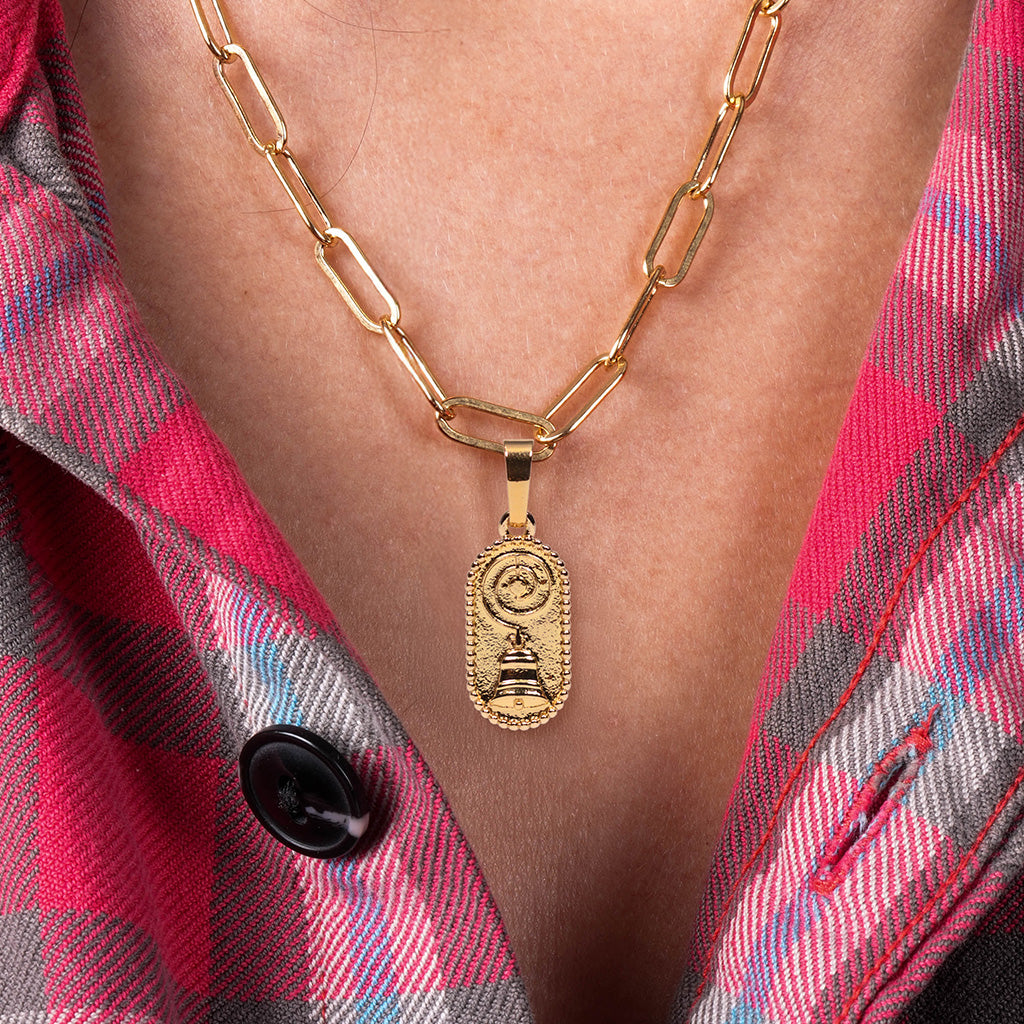 close-up of woman wearing DOWNTON ABBEY: THE GRAND FINALE Charm attached to the Paperclip Charm Chain