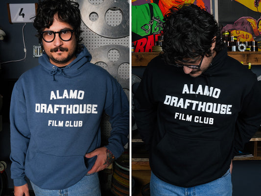 man wearing denim blue and black versions of the Alamo Drafthouse Film Club hoodie