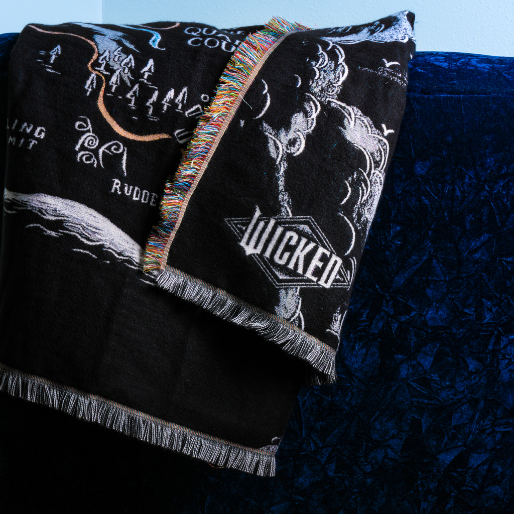 close-up of WICKED: FOR GOOD Map of Oz Blanket draped on chair