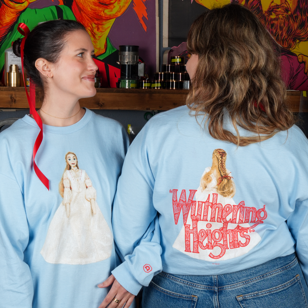 two women wearing the WUTHERING HEIGHTS shirt, showing the front and back